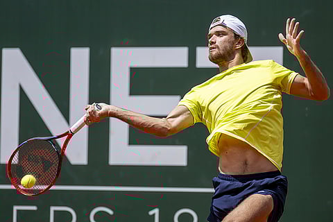 Tomas Machac returns to Novak Djokovic